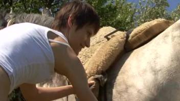 Slim short-haired animal enthusiast has intercourse with a massive horse penis