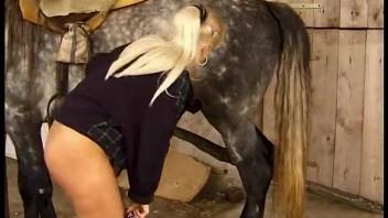 Experienced blonde woman screws and fellates a gray stallion in the stable