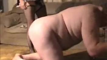 Experienced dominatrix observes her submissive being penetrated by a canine