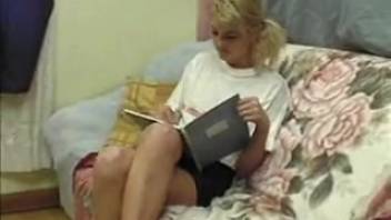 Partially nude blonde performs oral on a massive canine penis while being recorded.