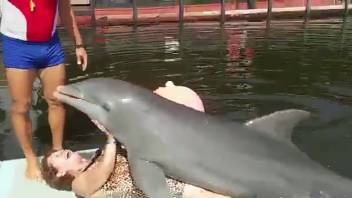 Dolphin grinding on a wavy-haired older woman