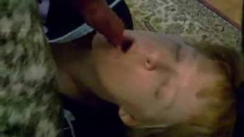 Elderly woman lies beneath the retriever, lovingly sucking his dick