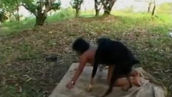 Hispanic woman being brutally mounted by a canine in doggy position outside