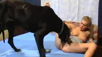 Brazen naked blonde shoves enormous dog cock into her bald pussy