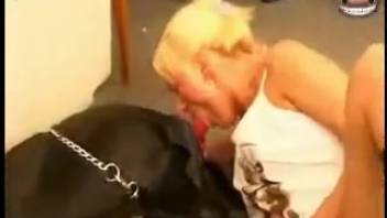 Handsome Doberman and sexy blonde in black boots performing oral sex
